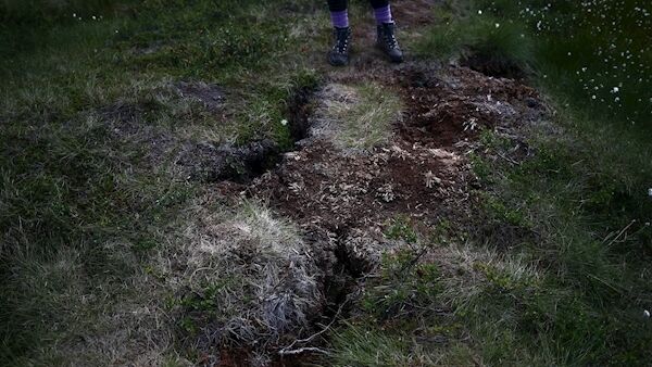 Kathryn Bennett stands next to an area of dry, cracked land at a research post at Stordalen Mire near Abisko. Picture: Hannah McLay/Reuters