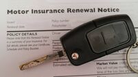 Close up of a car key on an auto insurance renewal document