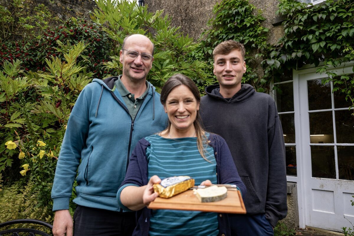 In the family garden, Sarah Furno holds a platter of Cashel Blue with her husband Sergio and their son Lucas, the third generation now involved in the business and carrying forward not only the making of the cheese but the values and traditions the family hold dear. Picture Chani Anderson