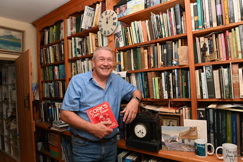UCC's Shane Lehane, holding a book of his father’s published cartoons that featured in The Evening Echo. Picture: Larry Cummins
