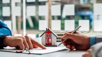 Customers interested in buying a home sign a signature to enter into a home purchase contract with a real estate agent. Mortgage