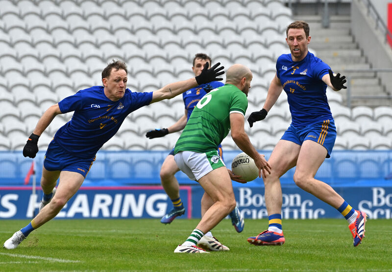  St Finbarr's players Sam Ryan and Jamie Burns looking to block down Frank Down, Ballincollig. Pic: Dan Linehan