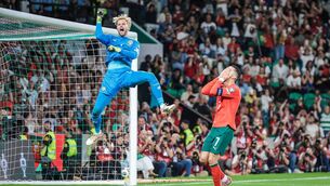 <p>CAOIMHÍN AND CRISTIANO: David Ribeiro's perfectly timed shot of the reaction to Cristiano Ronaldo's penalty, saved with his trailing leg by Ireland's Caoimhín Kelleher at Lisbon's Estádio José Alvalade. Pic: David Ribeiro/extratime.com</p>