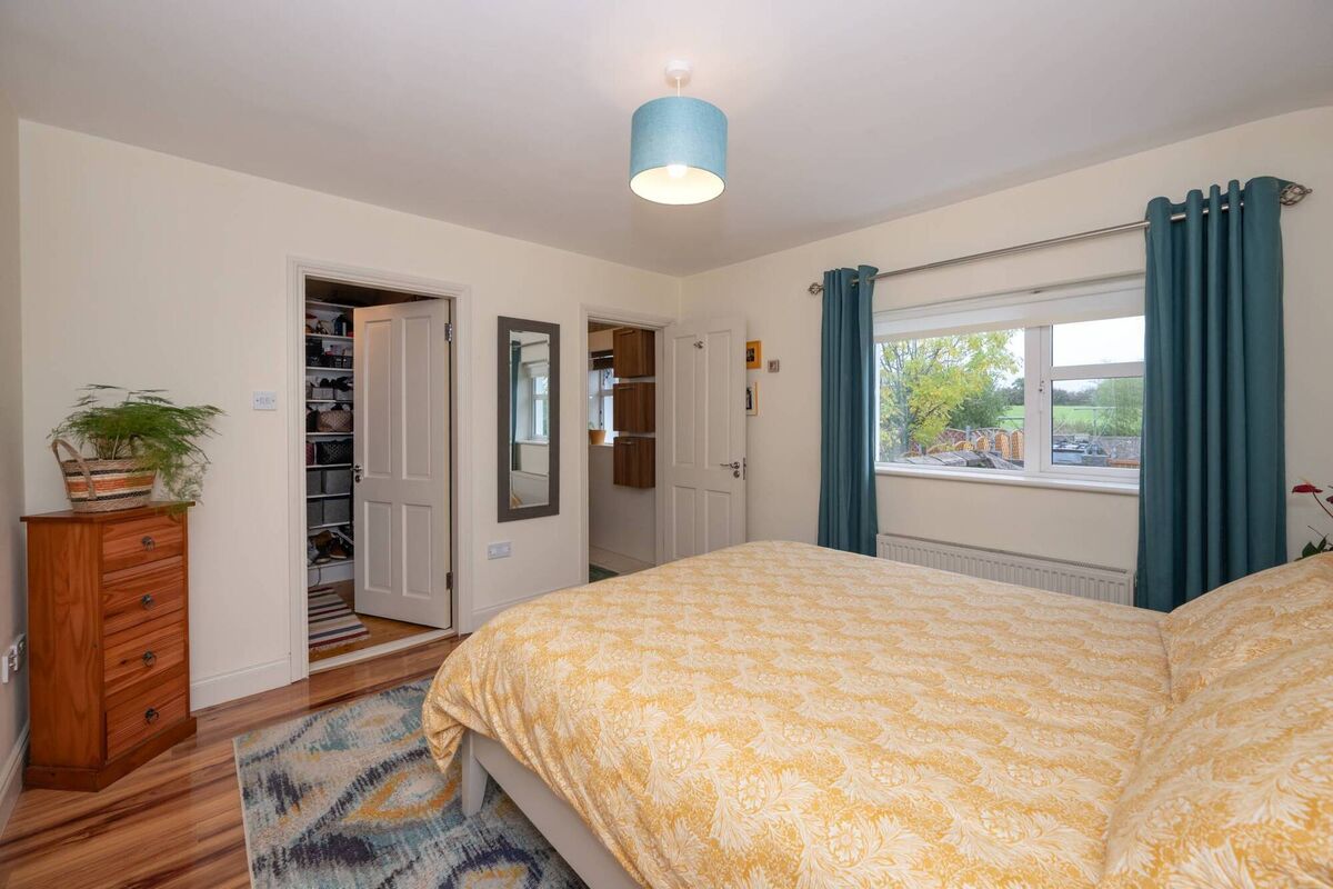 En suite bedroom with walk-in wardrobe En suite bedroom with walk-in wardrobe