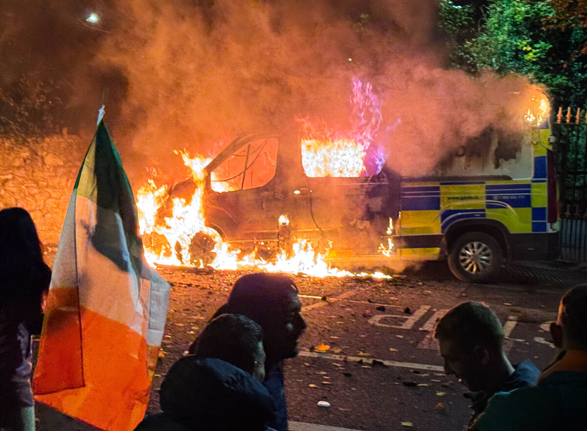 A Garda van burns outside the Citywest Hotel during the riots there last month. It is reported that more than 2,000 people assembled outside the hotel, which houses refugees and asylum seekers, after it was alleged that a 10-year-old girl was sexually assaulted by a man there. File picture: © RollingNews.ie