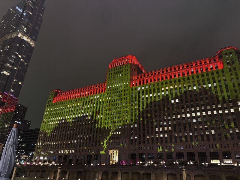 Art is projected onto the Merchandise Mart's facade at night