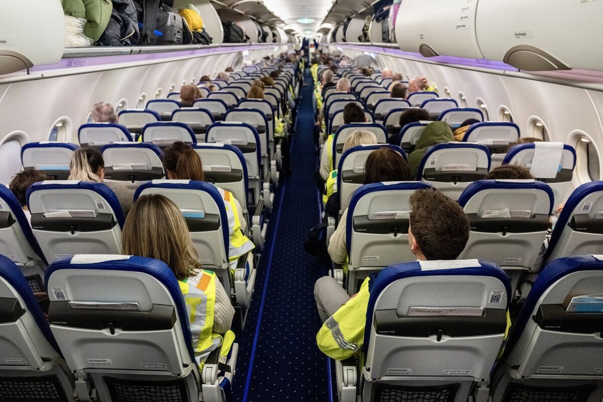 Inside the charter aircraft during Operation Trench, where garda escorts in high-visibility vests occupied aisle and window seats, leaving the middle seats for deportees. Picture: Chani Anderson