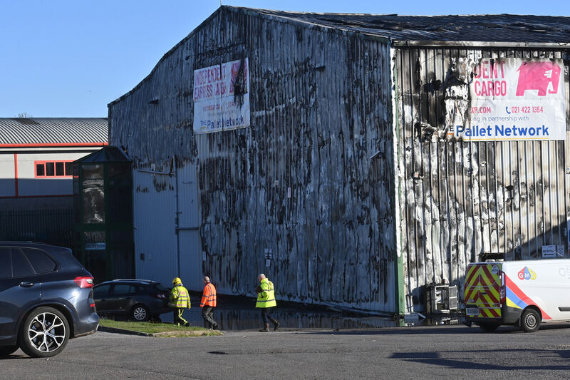  Members of the fire service inspect the distribution warehouse which was distroyed by fire in Ballytrasna, Little Island, Cork. Picture: Dan Linehan