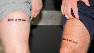 <p>Ireland fans Derek Byrne and Adam Bollard both from Coolock who got 'Pecked by the Parrot' tattoos arriving at Dublin Airport after attending the Ireland v Hungary soccer match in Budapest. Pictures: Gareth Chaney</p>