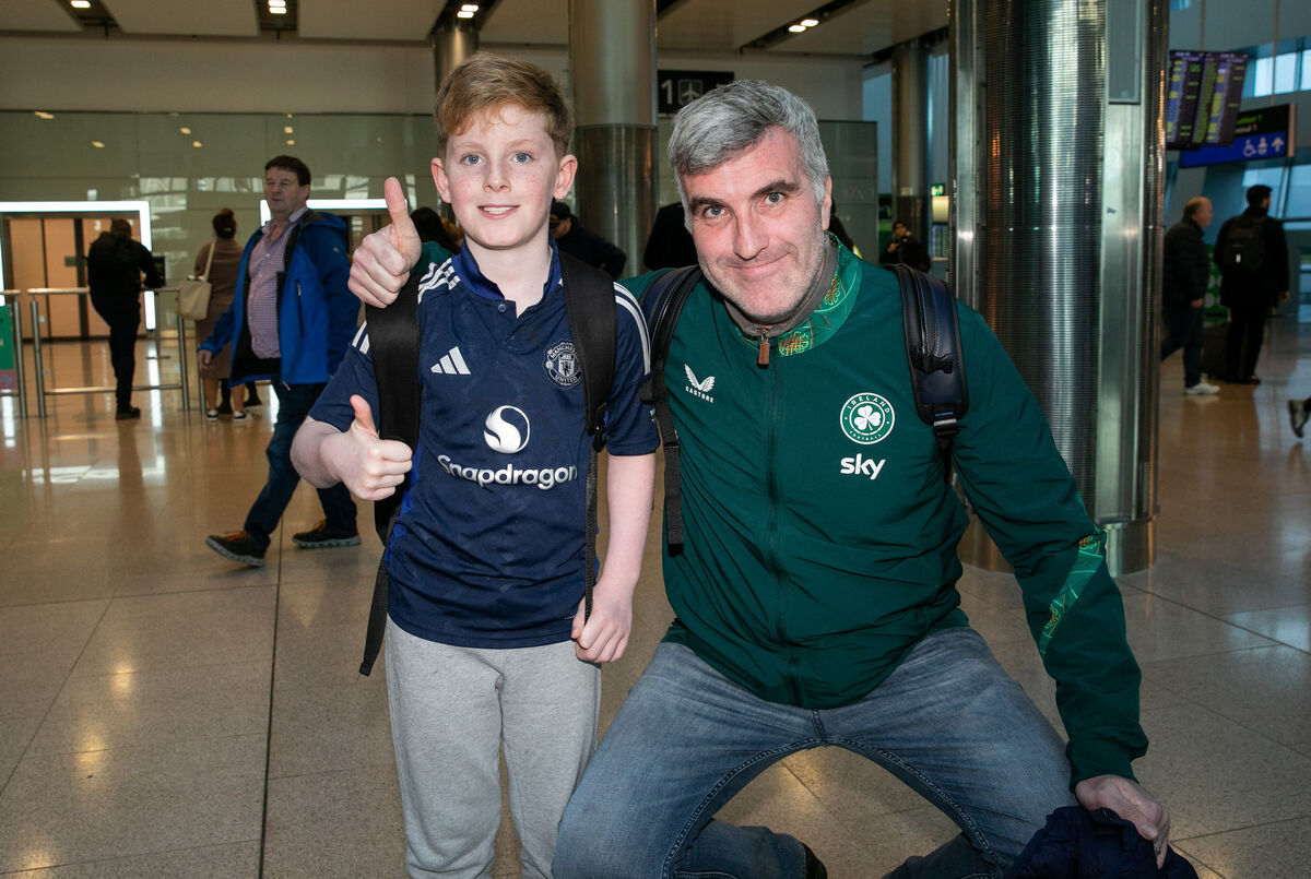 Ireland fans Patrick Keville and his son Finn Keville from Dublin 6 at Dublin Airport.
