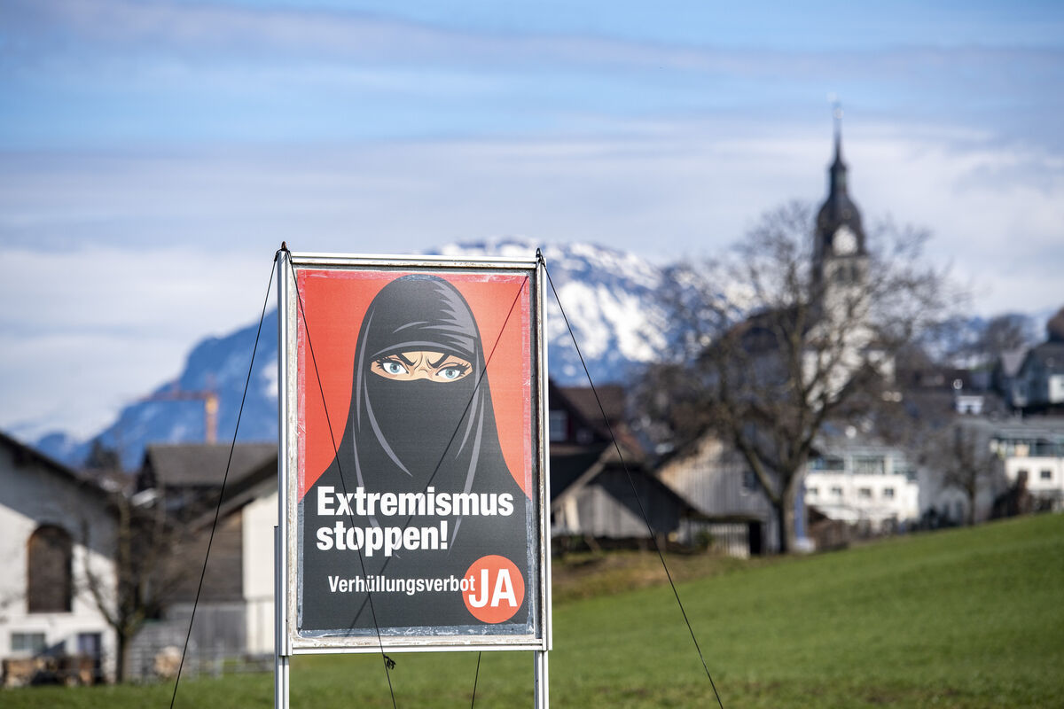 A poster supporting an initiative 'Yes to a ban on covering the face' on display in the village of Buochs in Switzerland in 2021. The wearing of the full-face veil has been banned in certain European countries, with partial bans in others. File photo: AP/Urs Flueeler/Keystone