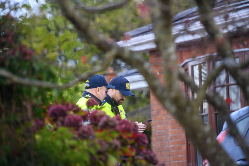  Garda members conduct door-to-door inquiries at Shrewsbury Downs in Ballinlough, Cork, following a fatal incident that left a woman dead and her husband seriously injured. Picture: Dan Linehan