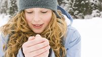 young woman warming up her hands.