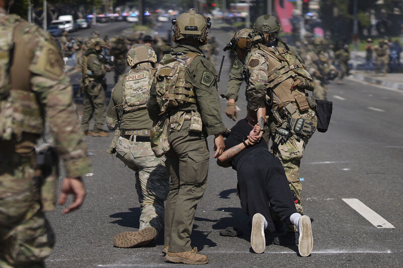 A man is detained during a protest in Paramount, California earlier this year after a swoop by ICE agents. Picture: Eric Thayer/AP
