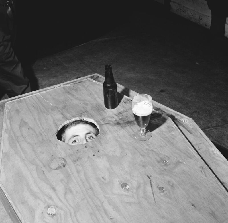33-year-old Mick Meaney from Ballyporeen, Co Tipperary, peering from his specially-made coffin at the Admiral Nelson pub in Kilburn, North London, in February 1968 before his interment in a yard nearby. Picture: Chris Ware/Keystone/Hulton/Getty