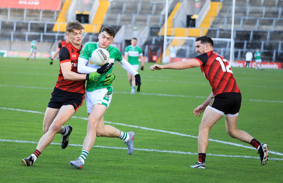 Aghabullogue's Luke Casey tries to get past Askeaton's Bill Casey. Pic: David Creedon