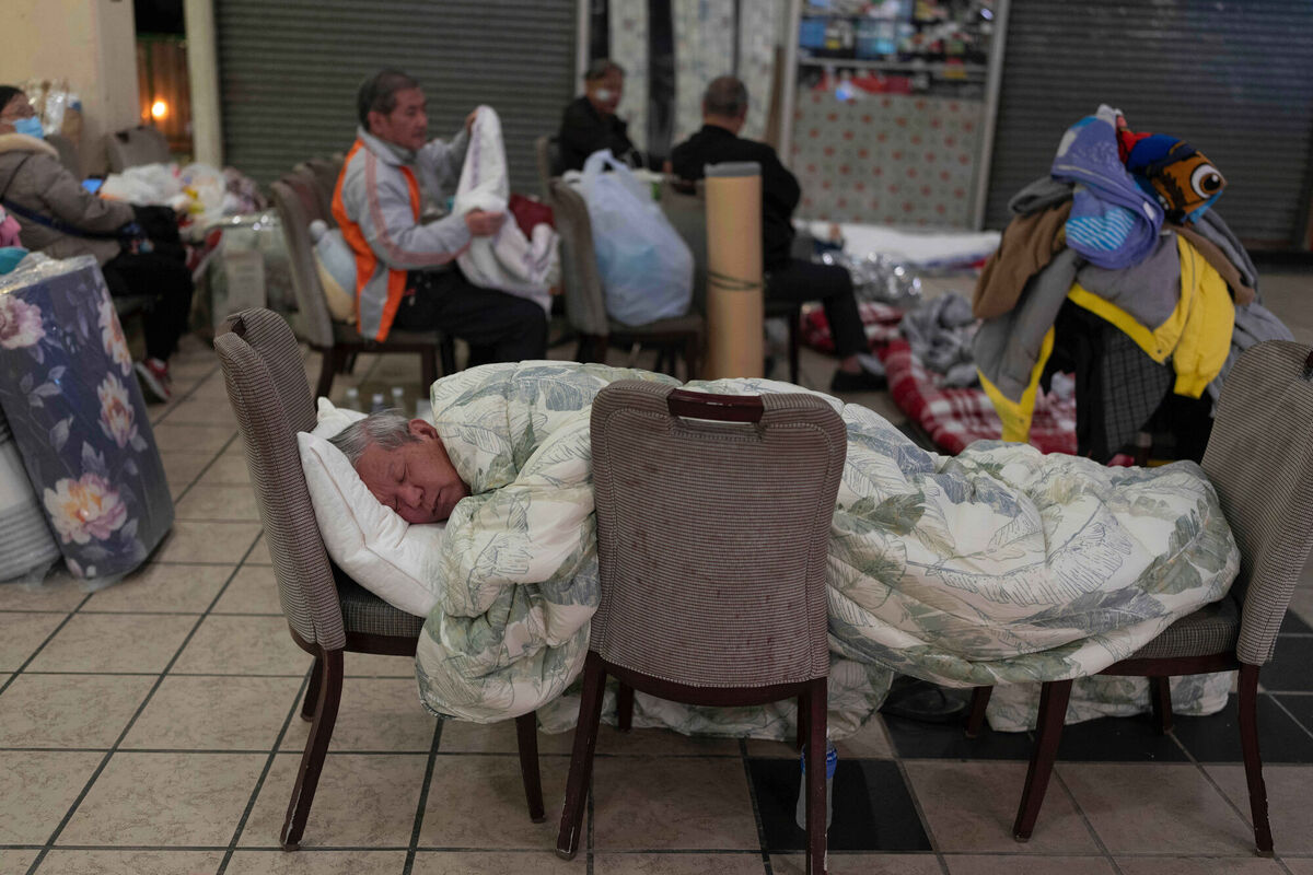 A man rests on a makeshift bed made up of chairs at a nearby shopping mall where residents are taking shelter in the aftermath of the fire at Wang Fuk Court, a residential estate in the Tai Po district of Hong Kong's New Territories, Thursday, Nov. 27 2025. (AP Photo/Ng Han Guan) A man rests on a makeshift bed made up of chairs at a nearby shopping mall where residents are taking shelter in the aftermath of the fire at Wang Fuk Court, a residential estate in the Tai Po district of Hong Kong's New Territories, Thursday, Nov. 27 2025. (AP Photo/Ng Han Guan)