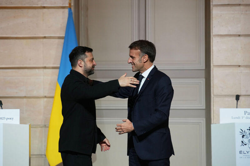 Emmanuel Macron, right, and Volodymyr Zelenskyy hug each other after a joint press conference at the Elysee Palace in Paris. Picture: Christophe Ena/AP