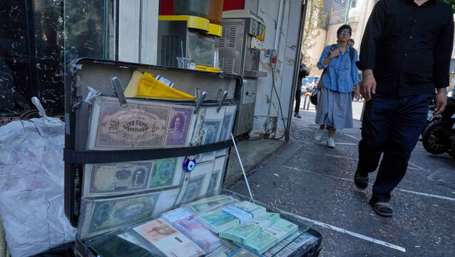 Current and pre-revolution Iranian banknotes displayed by a street money exchanger at Ferdowsi Square, Tehran’s main area for foreign currency exchange (Vahid Salemi/AP)
