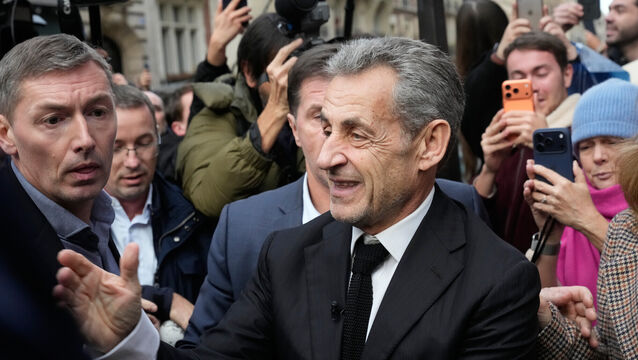 <p>Nicolas Sarkozy arrives to sign copies of his book at a Paris bookshop (Michel Euler/AP)</p>