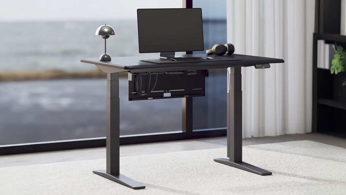 The integrated cable tray with the six-outlet power strip fitted neatly inside. Picture: FlexiSpot