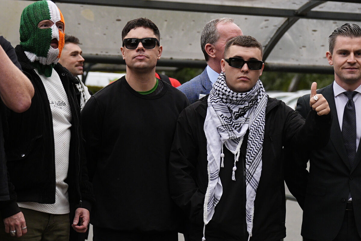 Kneecap's Liam Og O hAnnaidh (right, in keffiyeh), who performs under the stage name Mo Chara, with bandmates JJ O'Dochartaigh (left) and Naoise O Caireallain (centre) outside Woolwich Crown Court, London, where the terrorism case against him was thrown out by the chief magistrate following a technical error.
