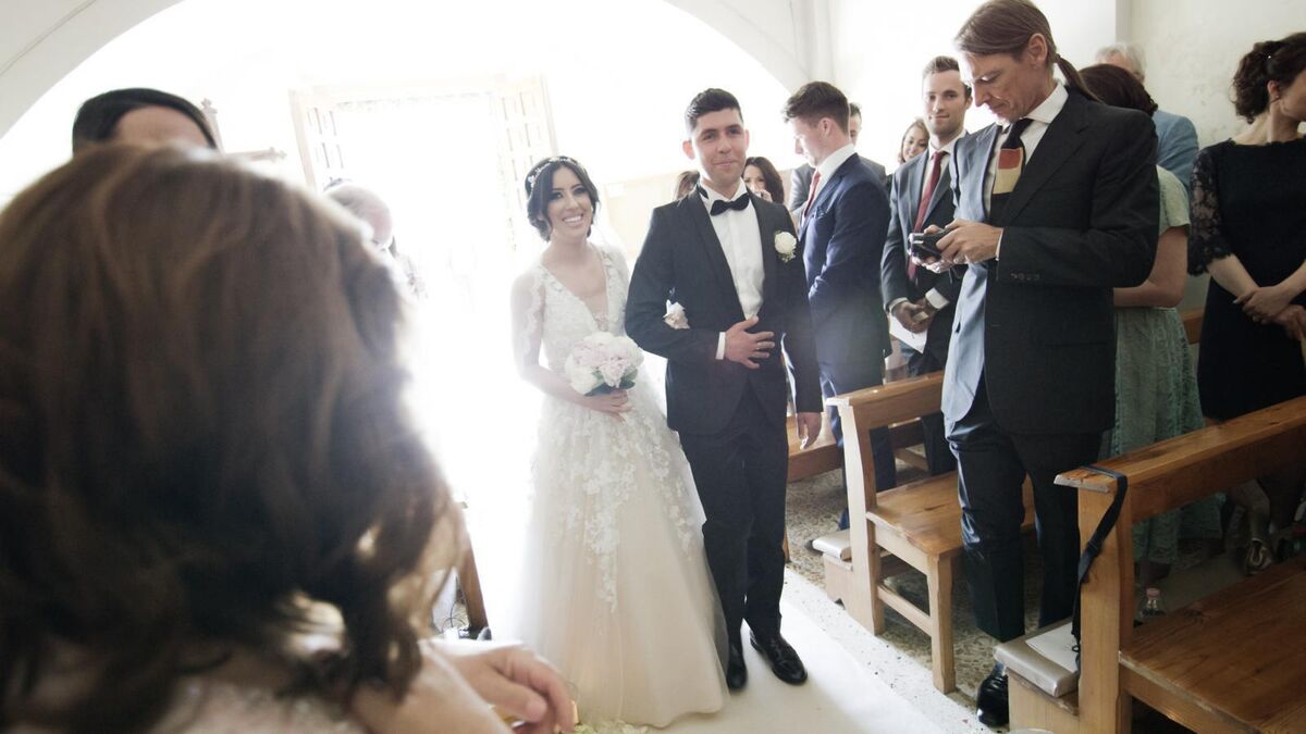Lottie Ryan and her husband Fabio walk down the aisle.