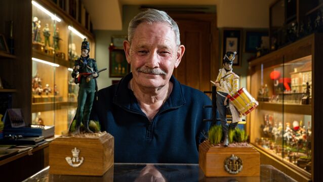 <p>Surrounded by finely detailed figures, David Edwards sits among pieces that reflect decades of collecting, crafting, and research. Picture: Chani Anderson</p>