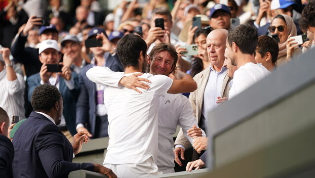 <p>Carlos Alcaraz celebrates his 2023 Wimbledon title with Juan Carlos Ferrero (Victoria Jones/PA)</p>