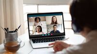 Woman studying at home with multiracial students via video conference