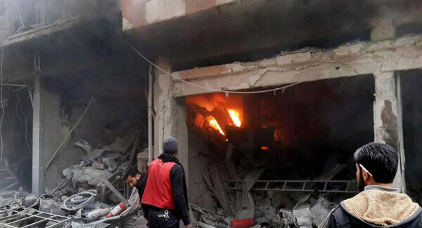 Syrians trying to extinguish fire that was caused by Syrian government aerial bombardment on the Damascus suburb of Douma, Syria.