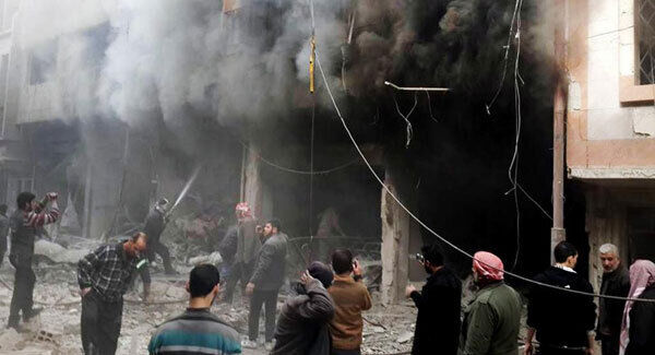 Syrians trying to extinguish fire that was caused by Syrian government aerial bombardment on the Damascus suburb of Douma, Syria.