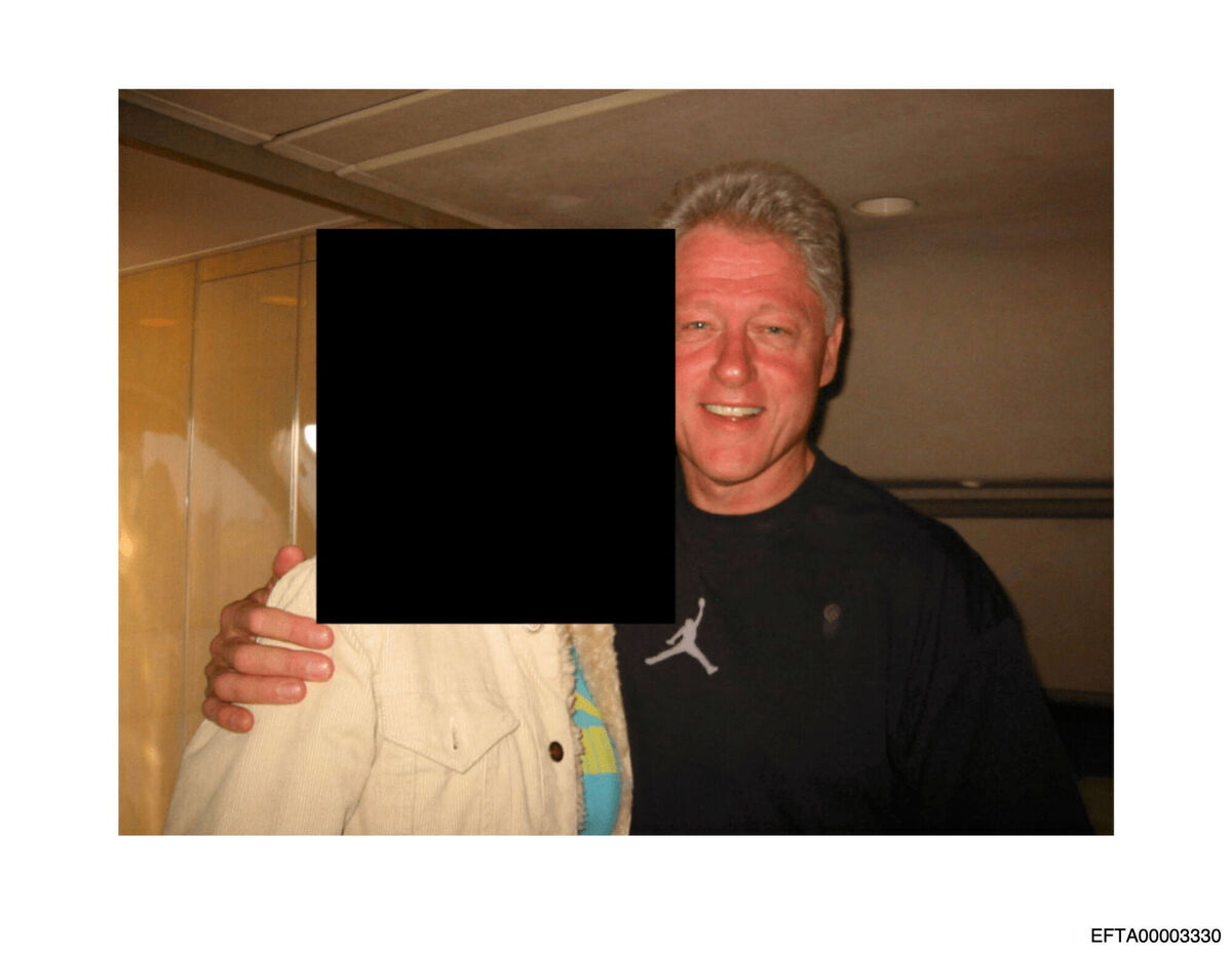 This undated, redacted photo released by the U.S. Department of Justice shows former President Bill Clinton with an unknown person. (U.S. Department of Justice via AP)