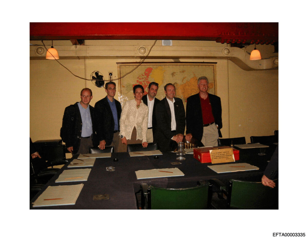 This undated photo released by the U.S. Department of Justice shows Ghislaine Maxwell, third from left, and former President Bill Clinton, far right, with a group of unknown people. (U.S. Department of Justice via AP)