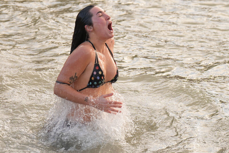 One participant's reaction to the icy cold water at the Forty Foot in Sandycove, Dublin, sums up everyone's notion of diving into the sea for a Christmas Day swim. Picture: Niall Carson/PA 
