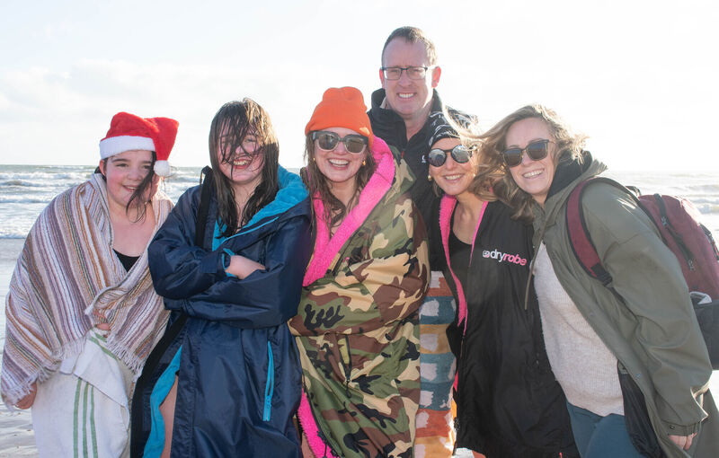 Ava Collins and Roisín, Fiona, and Danny Tonge, with Sam and Sarah Collins were well wrapped up following their Christmas Day swim in Youghal Co Cork. Picture: Howard Crowdy