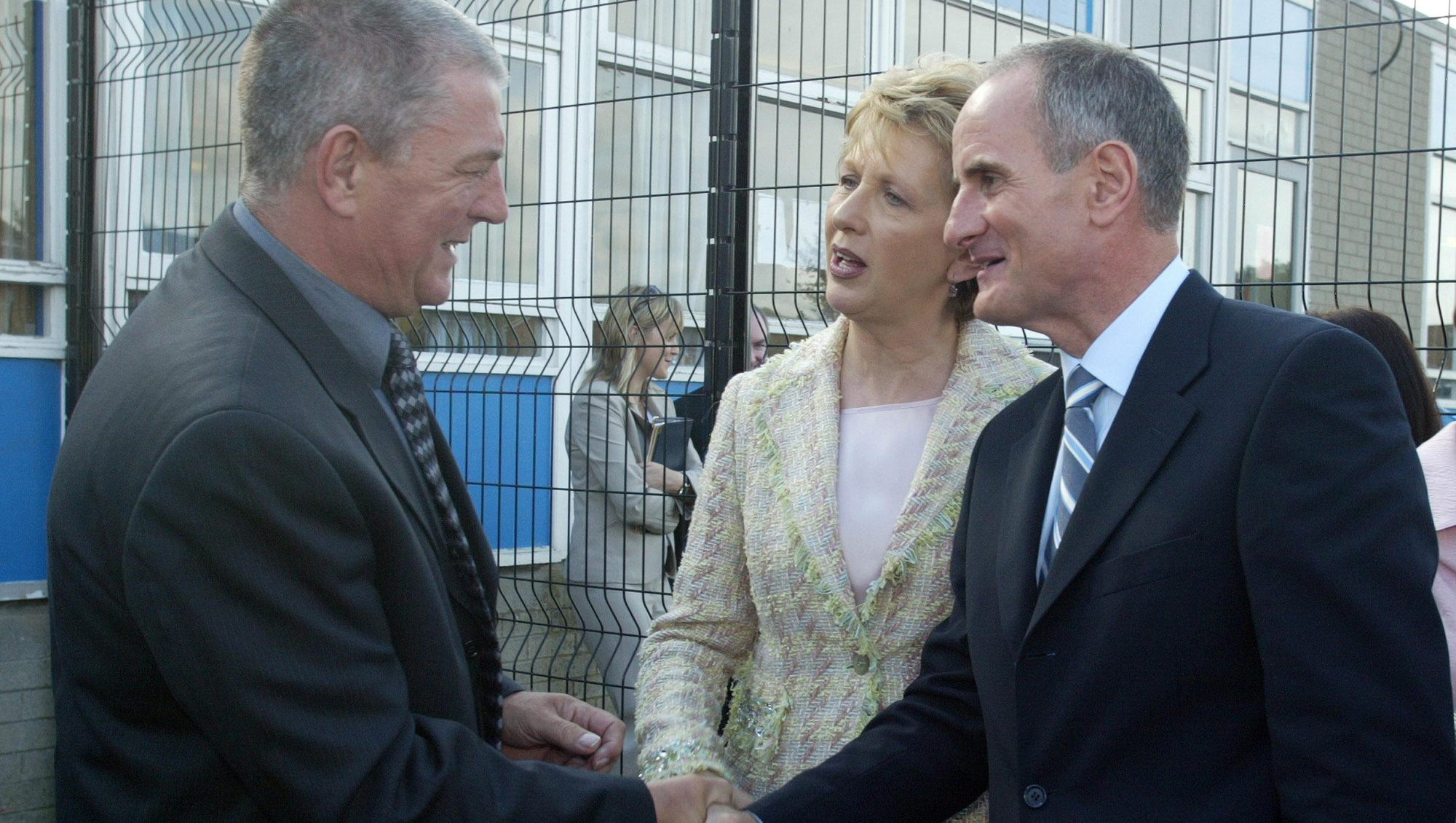 Former President Mary McAleese (centre) and husband Martin (right) are welcomed to Taughmonagh primary school by Loyalist leader, Jackie McDonald (left). Declassified files show that engagements included Martin McAleese laying on a coach for loyalist leaders to attend a golf outing, but they refused it over concerns that it would look 'too much like a UDA day-trip'.