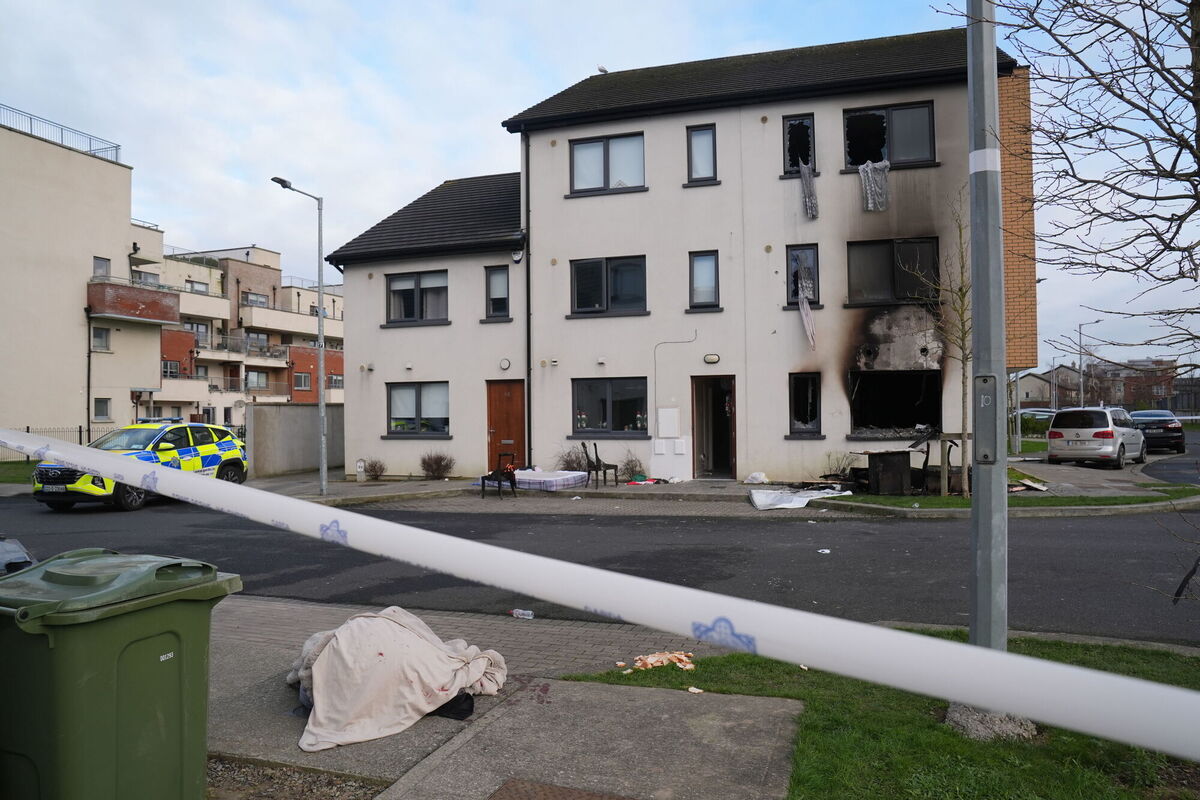 Garda at the scene in Finglas, County Dublin after two women and three teenagers were injured in a house fire. Picture: Brian Lawless/PA Wire