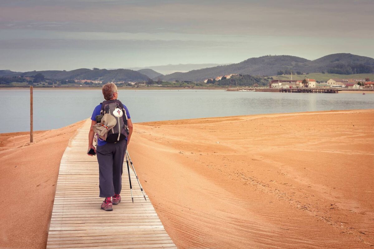 A pilgrim walking to catch the ship to Santona (Cantabria), way of St James, Spain. A pilgrim walking to catch the ship to Santona (Cantabria), way of St James, Spain.