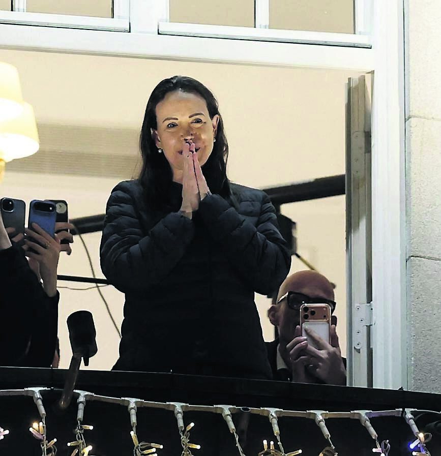 Nobel peace laureate María Corina Machado greets supporters from a balcony of the Grand Hotel in Oslo, Norway, in the early hours of December 11, 2025. 	Picture: Odd Andersen/ AFP via Getty
                    