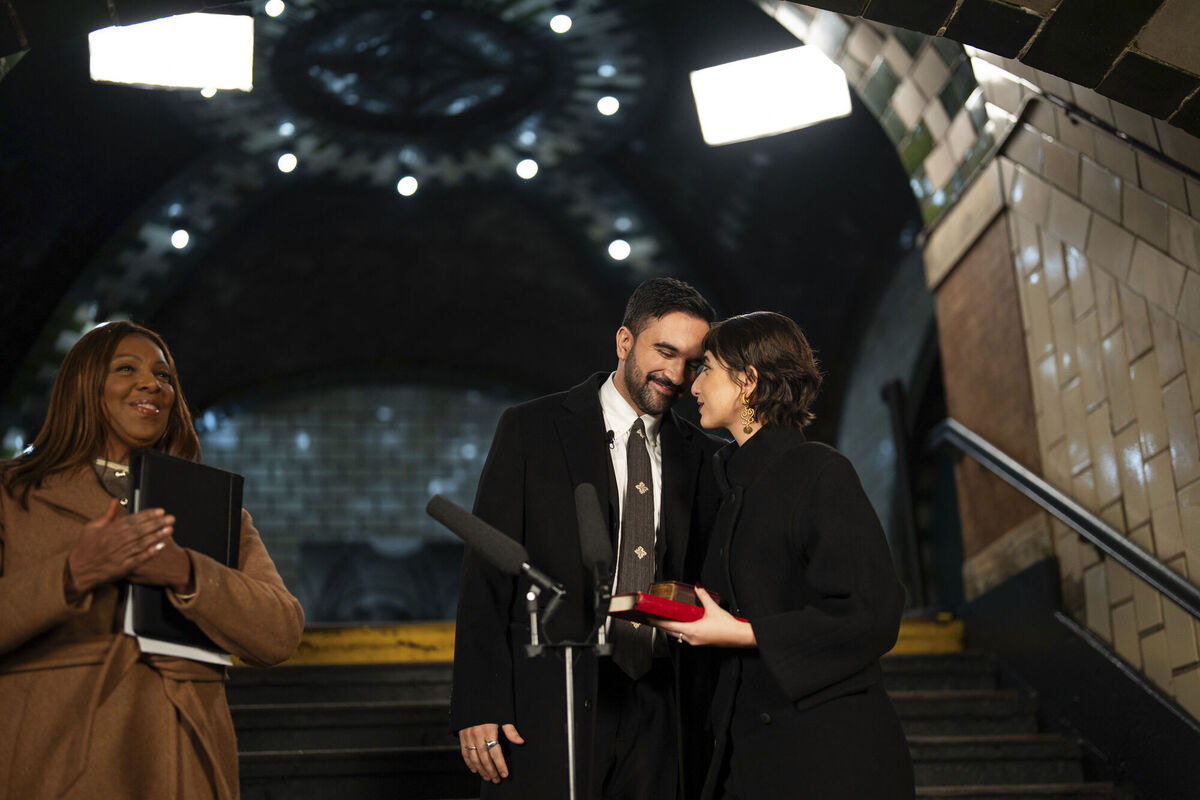 Mayor-elect Zohran Mamdani, center, shares a moment with his wife, Rama Duwaji, during a swearing-in ceremony in the Old City Hall subway station as Attorney General Letitia James, left, looks on Thursday, Jan. 1, 2026, in New York. (Amir Hamja/The New York Times via AP, Pool) Mayor-elect Zohran Mamdani, center, shares a moment with his wife, Rama Duwaji, during a swearing-in ceremony in the Old City Hall subway station as Attorney General Letitia James, left, looks on Thursday, Jan. 1, 2026, in New York. (Amir Hamja/The New York Times via AP, Pool)