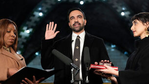 <p>New York Attorney General Letitia James, left, administers the oath of office to mayor-elect Zohran Mamdani, center, as his wife Rama Duwaji holds two Qurans, Thursday, Jan. 1, 2026, in New York. (AP Photo/Yuki Iwamura)</p>