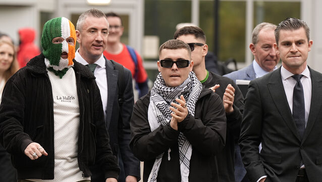 <p>The case against Kneecap’s Liam Og O hAnnaidh (centre, in keffiyeh), was thrown out by the chief magistrate following a technical error in the way the charge against him was brought (PA)</p>