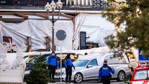 Police officers in the Crans-Montana resort inspect the area where the fire broke out (Jean-Christophe Bott/Keystone via AP)
