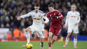 <p>Leeds’ Anton Stach (left) and Liverpool’s Florian Wirtz (right) battle for the ball (Peter Byrne/PA)</p>