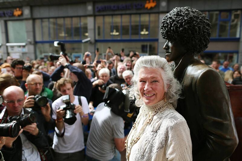  Phil Lynott's mother Philomena Lynott is surrounded by press photographers at the unveiling of the repaired statue of the Thin Lizzy frontman on Harry St off Grafton St, Dublin in 2013. Picture: Julien Behal/PA