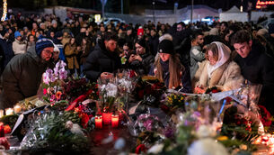 People lay flowers and light candles for the victims of the fire in Switzerland (Alessandro della Valle/Keystone via AP) People lay flowers and light candles for the victims of the fire in Switzerland (Alessandro della Valle/Keystone via AP)