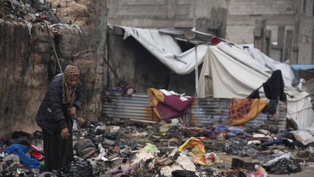 Fatima Abu al-Bayd inspects what remains of her mother’s tent at the Yarmouk displacement camp in Gaza City (Jehad Alshrafi/AP)