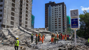 A rescue team works at the scene of a collapsed building in Nairobi(Andrew Kasuku/AP)
