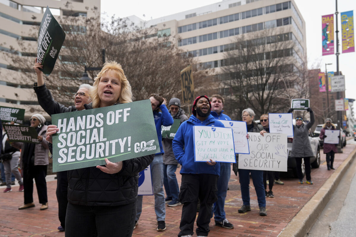 Demonstrators before a hearing regarding the Department of Government Efficiency's access to Social Security data.